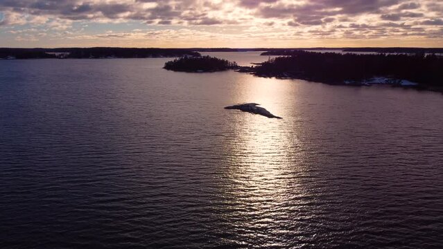 Flying towards the beautiful sunset above the Baltic sea archipelago, Sweden