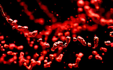 Drops of water splash red water on a black background, concept of freshness drink, watering the rain source of pure water fountain copy space
