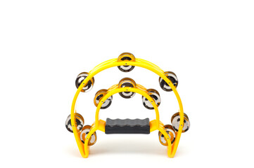 A tambourine with a plastic body and metal cymbals on a white background.