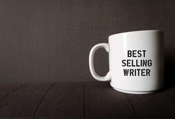 White coffee cup mug on gray copy space background with printed text on the side BESTSELLING...