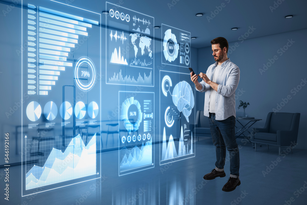 Poster guy using cellphone with abstract glowing blue business charts and graphs hologram on blurry office 