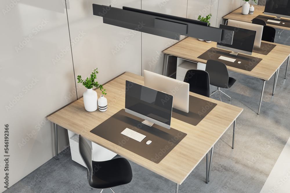 Aufkleber Side top view on eco style workspaces with modern computers on wooden tables in coworking office with concrete floor and light walls. 3D rendering