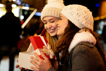 Portrait of happy women exchanging christmas presents. Holiday people christmas happiness concept