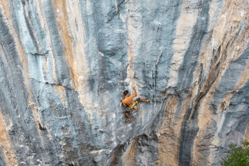 rock climber climbs the rock.