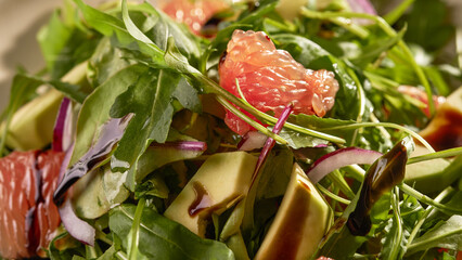fresh salad with arugula, grapefruit and avocado close up