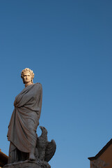 Fototapeta premium Sculpture of Dante Alighieri by sunset light