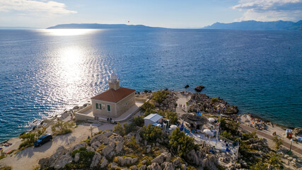 Fototapeta na wymiar Turquoise sea and stone beach by pine trees view, Dalmatia, Croatia