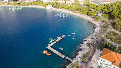 Turquoise sea and stone beach by pine trees view, Dalmatia, Croatia