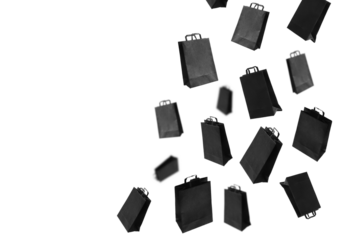 Black sale shopping bags are flying on transparent background with copy space. Sale banner concept. PNG.