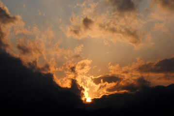 A magnificient view of sun hiding in the dark clouds during sunset looks mesmerizing as seen from Gangtok in Sikkim. Sunrise (dawn) and sunset (dusk) gives excellent view to capture in your camera.