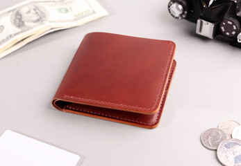 Brown leather purse on a gray background.
