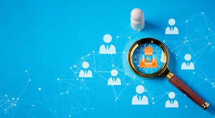 HRM or Human Resource Management, the magnifying glass focuses on the manager icon, which is one of the employee icons for recruiting leadership in human development and 