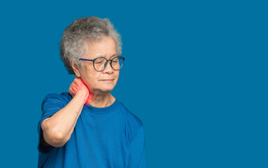 Senior woman suffering from neck pain standing over blue background