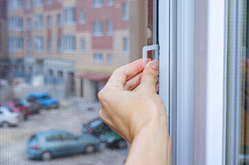 Protection against insects. Mosquito wire screen or mosquito net on a PVC window.