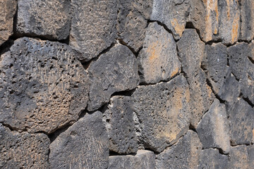 Detail plan of the textures of the stones of an old wall. Black volcanic stone wall.black volcanic stone blocks. Tenerife, Canary Islands, Spain. 