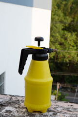 Fototapeta na wymiar Yellow bottle spray in the garden 