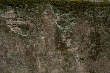 Old shabby stone wall with mould and stains