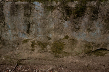 Old shabby stone wall with mould and stains