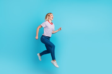 Fototapeta na wymiar Full length photo of pretty girl jumping up careless smiling overjoyed isolated on blue color background