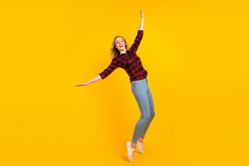 Fototapeta na wymiar Full size view of nice-looking cheerful glad wavy-haired girl having fun isolated on vivid color background