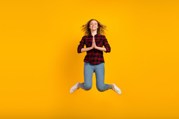 Fototapeta na wymiar Full body view of lovely cheerful wavy-haired girl jumping hands plead isolated on bright vivid shine vibrant background