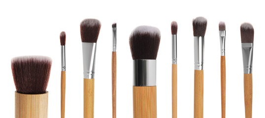 Set with different makeup brushes for applying cosmetic products on white background. Banner design