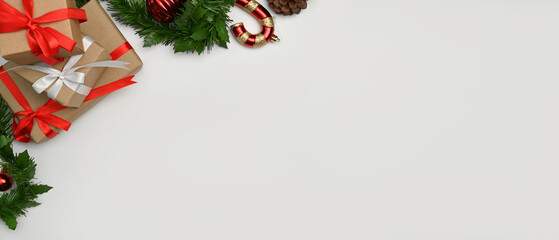 Christmas gifts and fir tree branches on white background. Flat lay, top view with copy space for your text