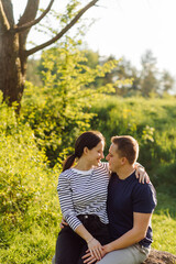Obraz premium A young couple in love walks in the woods, having a good time together