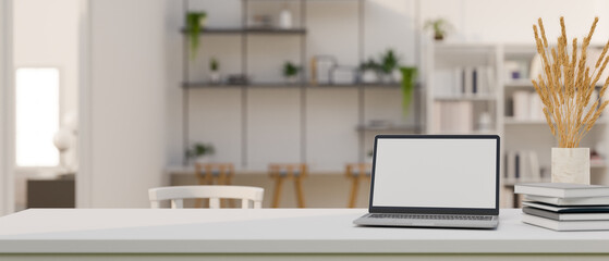 Modern bright workspace with laptop mockup over blurred modern co-working space in background.