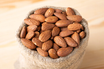 Close up shot of bag of almond. Full linen bag of almond nuts