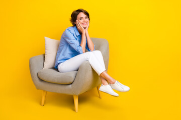 Fototapeta na wymiar Full length photo of shiny adorable lady wear blue shirt smiling empty space isolated yellow color background