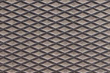 Rhomboid anti-slip texture of an old and dirty metal surface.