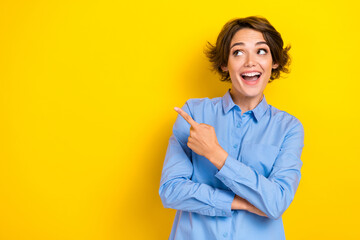 Closeup photo of young adorable pretty girl wear blue denim shirt worker ceo owner company finger point information excited isolated on yellow color background