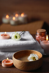 Obraz na płótnie Canvas Beautiful spa composition with burning candles and flowers on wooden table