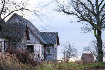 Abandoned, vandalized residential building. Broken glass, slum, desolation. Defocused.