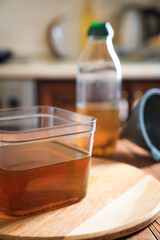 Used cooking oil on wooden table in kitchen, closeup
