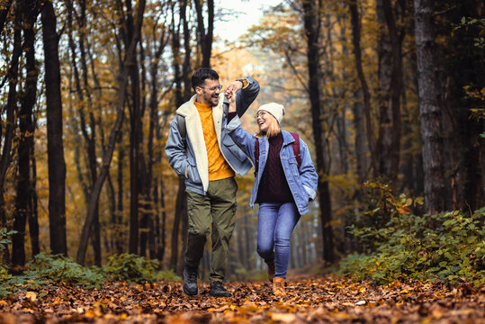 Couple spending time together walking in forest.