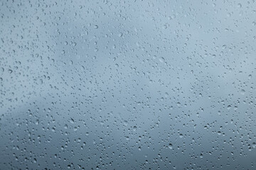 Window glass with water drops, closeup. Rainy weather