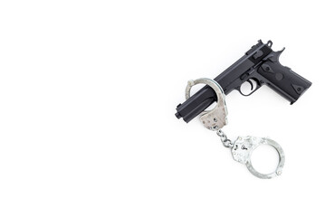 Hand gun weapon with handcuffs. Arrest of a criminal concept