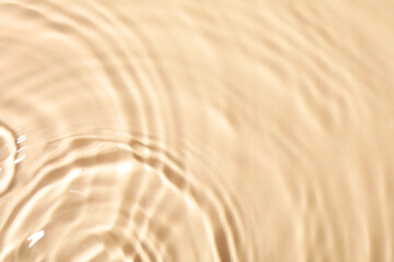 Fototapeta na wymiar Closeup view of water with rippled surface on beige background