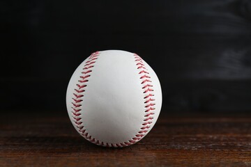 Baseball ball on wooden table, closeup. Sportive equipment