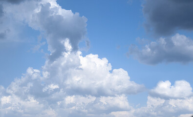 Naklejka na ściany i meble Beautiful fluffy clouds on light blue sky as background