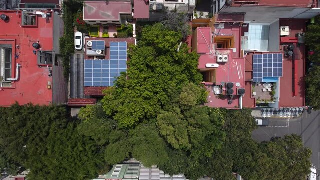 Aerial view of solar panels mounted on the roof of houses located in Mexico City, Mexico.