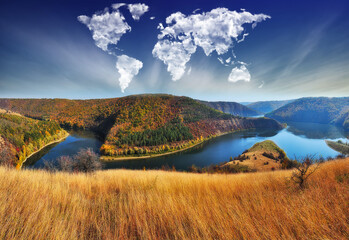 clouds in the form of a world map over the river canyon. Travel and landscape concept. autumn morning