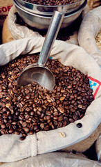 Coffee beans with a scoop in it close up, with calm colors,