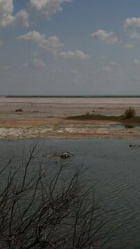 - Panning footage of a flowing creek in a salt lake plain