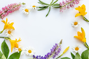 Beautiful wild meadow flowers and herbs flat lay