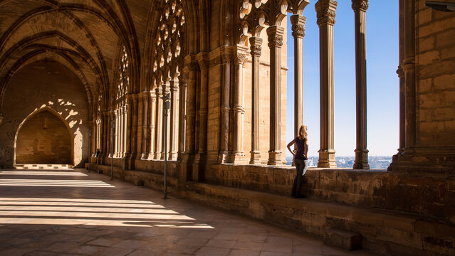 woman looking at city landscape view in a cloister- Lerida in Catalonia