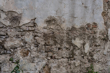Old stone wall with chipped paint, textured, background
