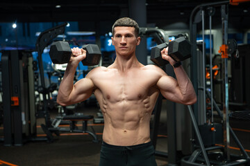 Fototapeta na wymiar sport athlete do weightlifting with dumbbell in fitness gym. weightlifting practicing athlete in gym